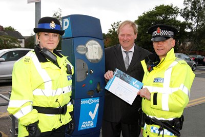 PCSO Joanne Messenger and PC Jonathan Darwent of Stretford Neighbourhood Policing Unit present Colin McCory of Stretford Mall with The Safer Parking Award