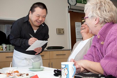 Cartrefi Conwy's Kennedy Court Brunch Club, Old Colwyn with students from students from Llandrillo College doing the catering. Pictured is student Sam Hou Yau taking an order from residents.