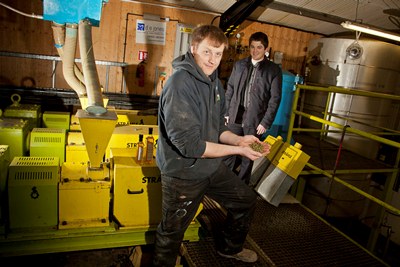 Llyr Jones with his Blodyn Aur rapeseed oil at his farm near Cerrigydrudion with Rob Price from Cadwyn Clwyd.