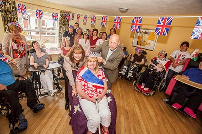 Queen's Jubilee events at Pendine Park Care Homes. The Queen for a Day at Penybryn, Joanne Davies is crowned by Mario and Gill Kreft
