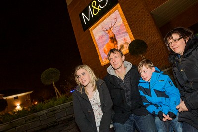 Projected art works on Eagles Meadow, Wrexham. Nigel and Angela Hughes with their children Elen, 16 and Lewis, 8.
