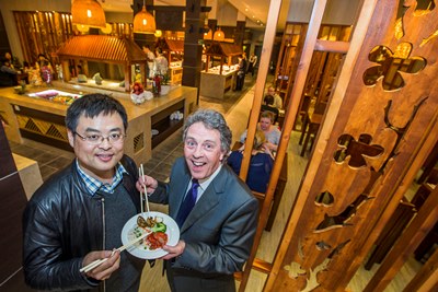 Kevin Critchley, centre manager at Eagles Meadow in Wrexham with Chen Zhang at the Real China restaurant which opened its doors last night (Wednesday).