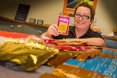 Vikki Lomas at Copop Travel at Stretford Mall with some of the cat food they have collected for its annual Christmas animal sanctuary collection