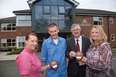 PENDINE PARK - BODLONDEB ... Minister for Health and Social Services Mark Drakeford visits pendine parks Bodlondeb. Pictured presenting members of staff Katie Topman, James Bowden and Beth Mullock with their awards during his visit is .