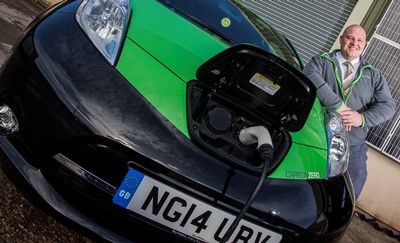Gareth Jones of Carbon Zero in St Asaph with his new car, an all electric Nissan Leaf.