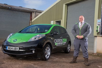 Gareth Jones of Carbon Zero in St Asaph with his new car, an all electric Nissan Leaf.